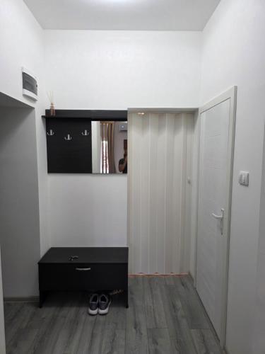 a room with a black dresser and a mirror at EXCLUSIVE Plus in Vršac
