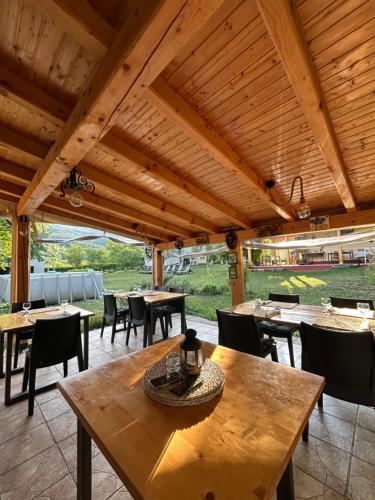 an outdoor dining area with tables and chairs at Apartments Celopek in Ličko Petrovo Selo