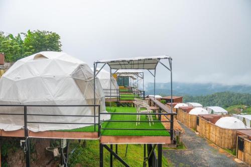 a gazebo with tents on top of a hill at ภูวินคาเฟ่ โฮมสเตย์ Phuwin Homestay Monjam in Mon Jam