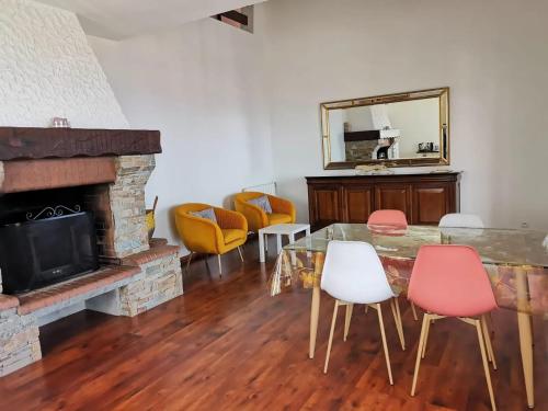 a living room with a table and chairs and a mirror at Appartement Vue Mer à Bastia, terrasse et piscine privée. in Bastia