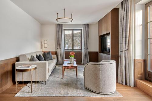 a living room with a couch and a table at Hotel GRACE LA MARGNA ST MORITZ in St. Moritz