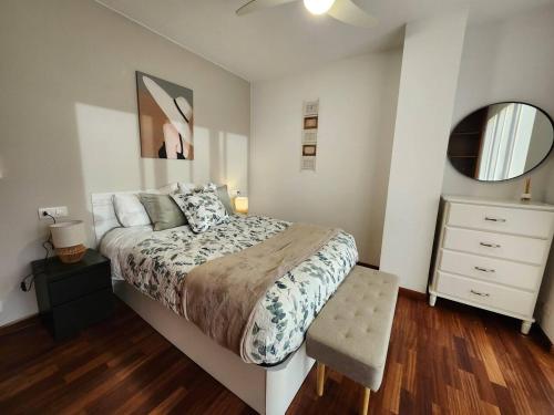 a bedroom with a bed and a dresser and a mirror at Apto Carballo - NETFLIX y calefacción in Carballo