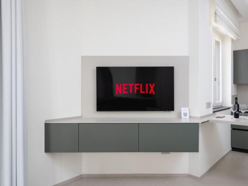 a tv on a white wall in a kitchen at Blu Sky Luxury Palace Sorrento Coast in Meta