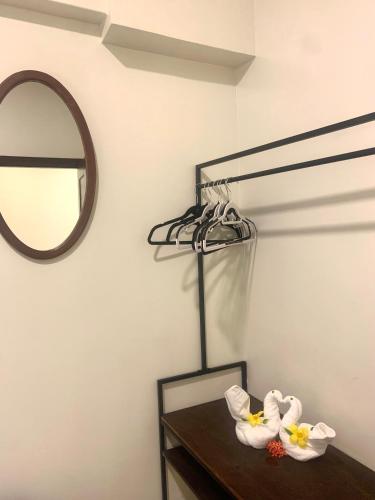 a room with a mirror and a table with towels at Louis' Apartments in Placencia Village