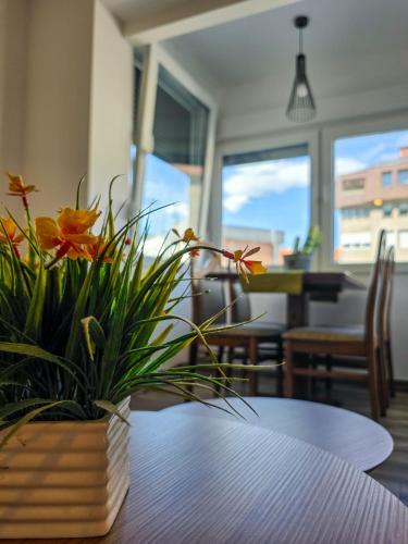 a table with a vase of flowers on top of it at Urban Nest in Jajce