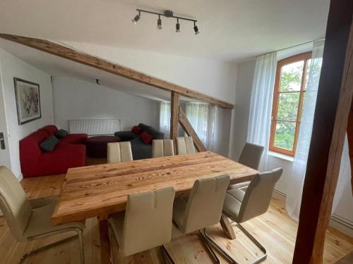 a dining room with a wooden table and chairs at Inselperle Loft-Studio in Fehmarn