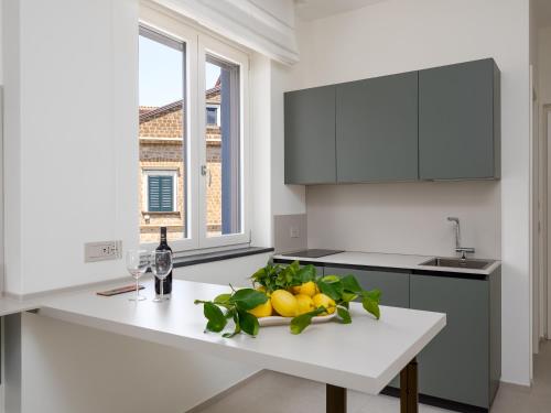 a white kitchen with a white counter and a window at Blu Sky Luxury Palace Sorrento Coast in Meta