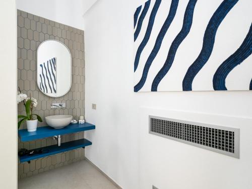 a bathroom with a sink and a mirror at Blu Sky Luxury Palace Sorrento Coast in Meta