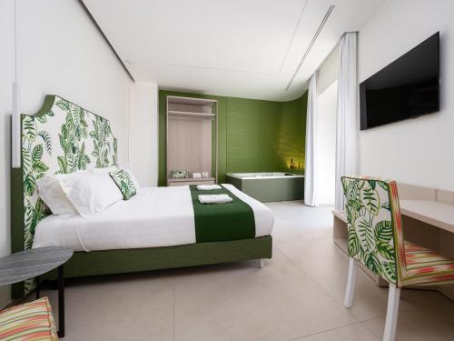a hotel room with a bed and a bathroom at Blu Sky Luxury Palace Sorrento Coast in Meta