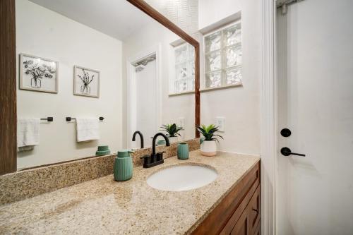 a bathroom with a sink and a mirror at Sunrise Serenade - Sun-Soaked FLL Getaway - Pool - BBQ - Near Beaches in Sunrise
