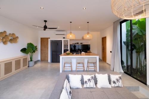 an open kitchen and living room with a couch at Villa Chilla - New Modern Loft in Prime Uluwatu in Uluwatu