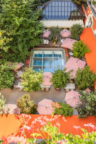 a group of chairs with umbrellas on a patio at Hôtel Le Royal Monceau Raffles Paris in Paris