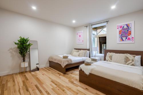 a bedroom with two beds and a couch in it at City Verve Modern 2BR in NDG MTL in Montréal