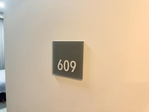 a black sign on a wall with at ST Studios Vila Mariana by Housi in Sao Paulo