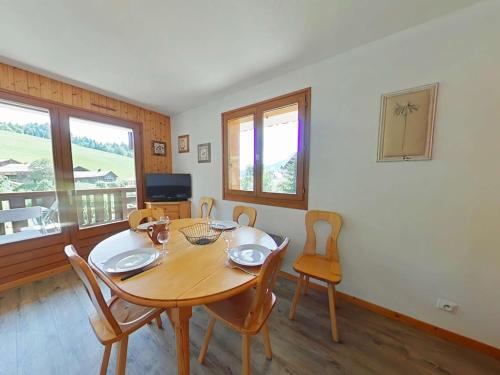une salle à manger avec une table et des chaises en bois dans l'établissement Appt 2 pièces, 6 pers, proche pistes, parking, animaux admis - FR-1-241-16, au Grand-Bornand