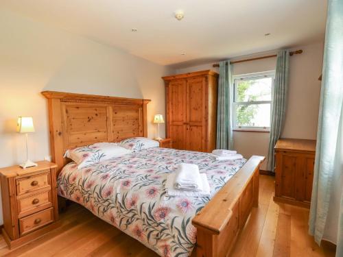 a bedroom with a large bed and a window at Ash House in Ballyvaughan