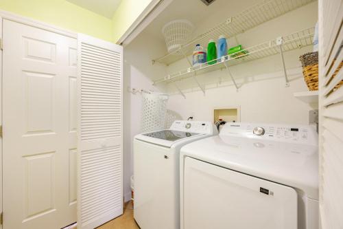 a white laundry room with a washer and dryer at Relaxing place with pool in Cape Coral