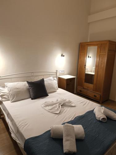 a bedroom with a bed with towels on it at Anesis Hotel in Loutra Edipsou