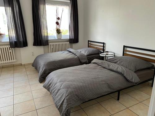 Postel nebo postele na pokoji v ubytování Monteurwohnung am Heideresort Brüggen