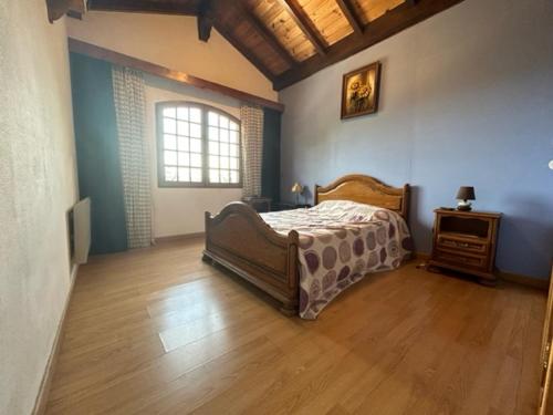 une chambre avec un lit et un parquet dans l'établissement Maison du Bonheur, à Taluyers