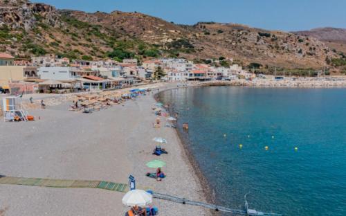 a group of people on a beach with the ocean at Aphea Village in Kolymvari