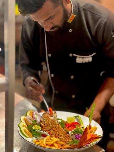 a man is eating a plate of food at AHAS GAWWA Boutique in Padukka