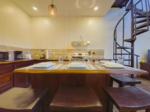 a kitchen with a large island in the middle at Louis' Apartments in Placencia Village