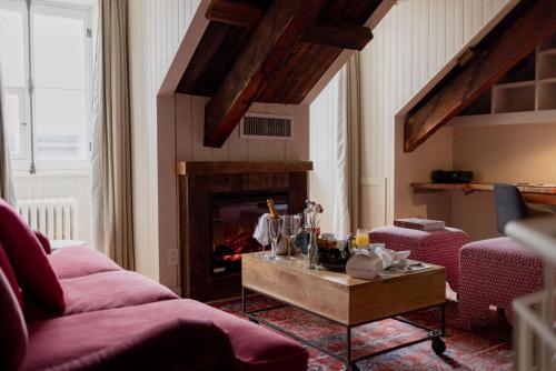 a living room with a couch and a fireplace at Auberge Saint-Antoine in Quebec City