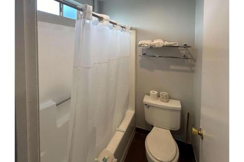 a white bathroom with a toilet and a shower at Studio 6 North Las Vegas, NV in Las Vegas