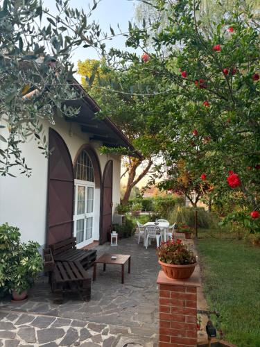 a patio of a house with a bench and a table at Casa Alima in Suvereto