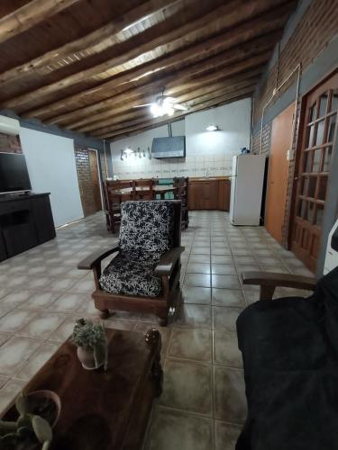 a living room with a couch and a table and a refrigerator at Carpe Diem! Brand new in Malargue in Malargüe