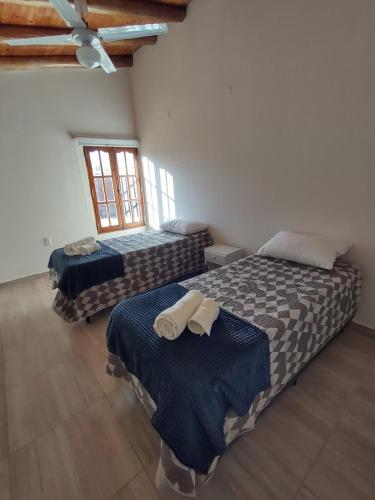 a bedroom with two beds with towels on them at Carpe Diem! Brand new in Malargue in Malargüe