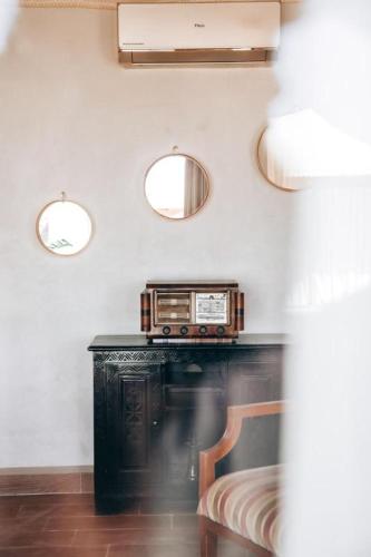 a room with a table with a radio on the wall at Agafay Yes We Camps & Spa in El Karia