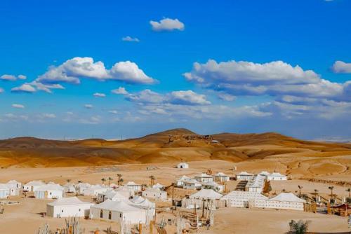 a small village in a desert with at Agafay Yes We Camps & Spa in El Karia