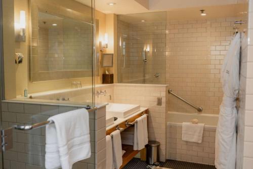 a bathroom with a tub and a sink and a shower at Auberge Saint-Antoine in Quebec City