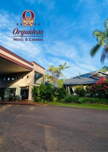 a hotel with a sign on the front of it at Orquideas Hotel & Cabañas in Puerto Iguazú