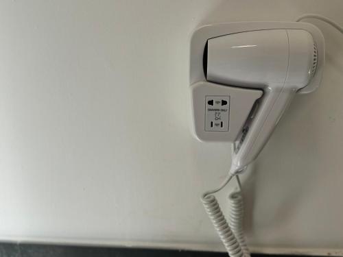 a hairdryer hanging on a wall at Montecristo B&B in Grosseto