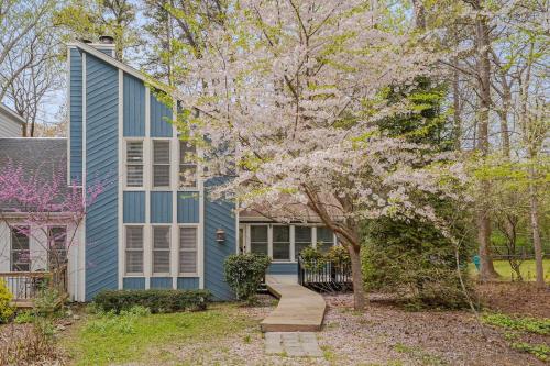 a home with a blue house and a tree at Cozy Fully-Renovated 2 BRM 2 Bath Near North Hills in Raleigh