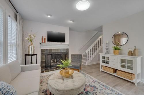 a living room with a couch and a fireplace at Cozy Fully-Renovated 2 BRM 2 Bath Near North Hills in Raleigh