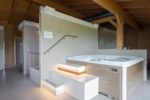 a bathroom with a tub and a sink and stairs at Agri-Hotel Da Marianna Resort & Spa in Santa Domenica Vittoria