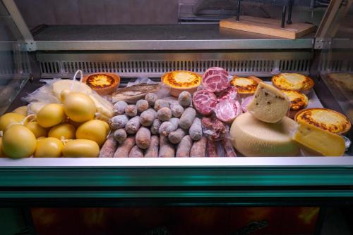 a display case filled with lots of different types of food at Agri-Hotel Da Marianna Resort & Spa in Santa Domenica Vittoria