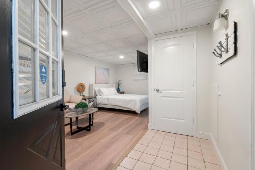 a room with a bed and a door leading to a bedroom at The Beachside in Sylvan Beach