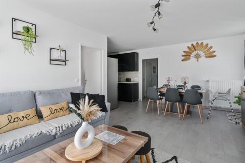 un salon avec un canapé et une table dans l'établissement Park' Avenue Cocon pour 6 personnes à Disneyland, à Serris