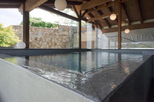 an indoor swimming pool with water in a building at Agri-Hotel Da Marianna Resort & Spa in Santa Domenica Vittoria
