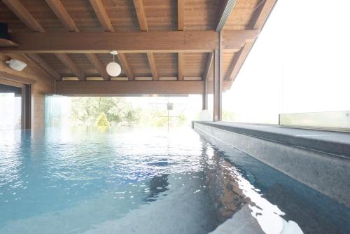a swimming pool with water in the middle of a building at Agri-Hotel Da Marianna Resort & Spa in Santa Domenica Vittoria
