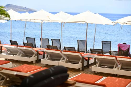 a group of chairs and umbrellas on a beach at MyElla Boutique Hotel in Mugla