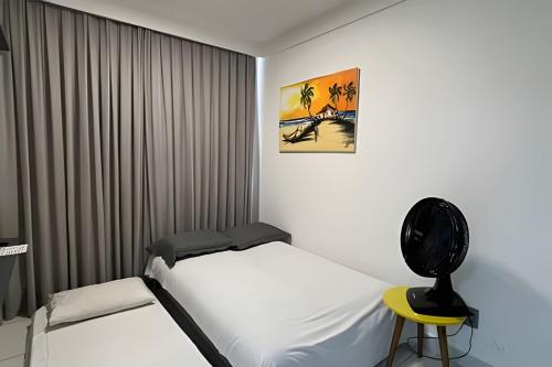 En eller flere senge i et værelse på Flat pé na areia c/ vista mar Branco Haus - MyFlats