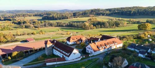 an aerial view of a large white building with red roofs at Hotelový a jezdecký areál Dvůr Krutěnice in Krutěnice