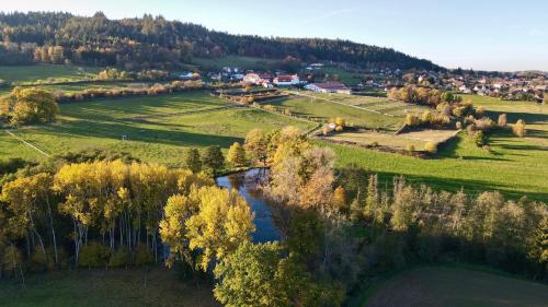 an aerial view of a field with a river at Hotelový a jezdecký areál Dvůr Krutěnice in Krutěnice