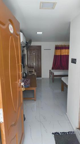 a living room with a couch and a table at Temple View Home Stay in Tiruvannāmalai